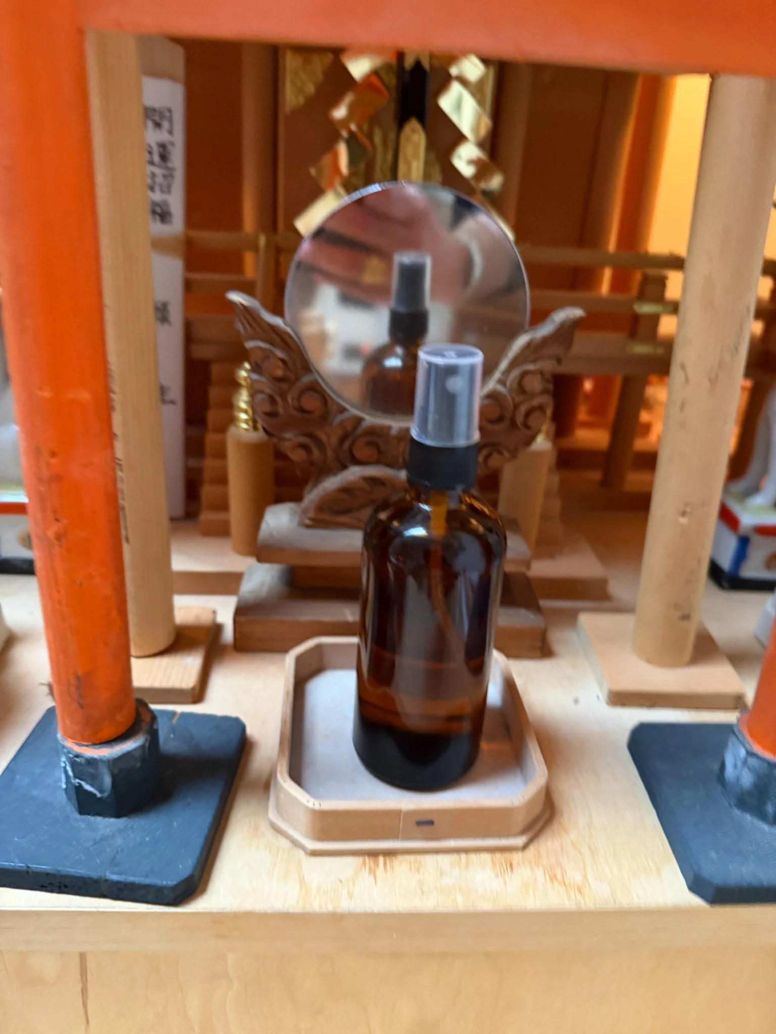 Representative amber Jow bottle before a small shrine mirror